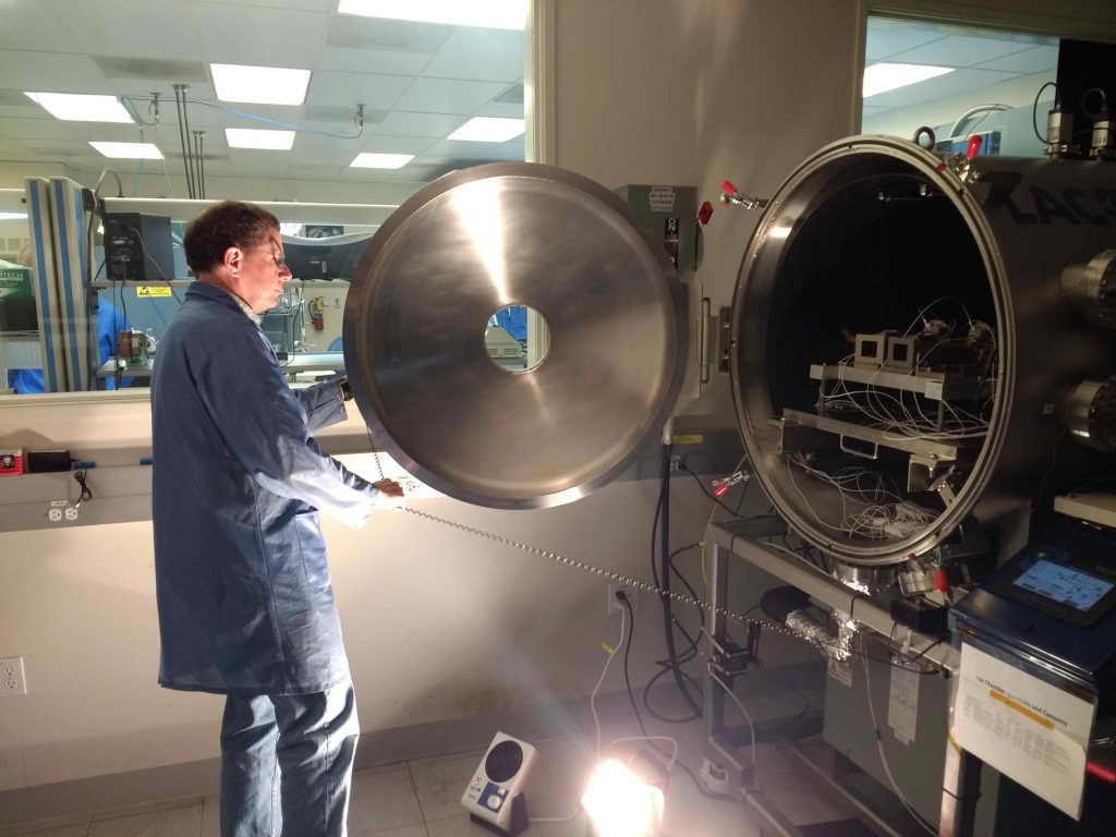 Mastcam-Z lead systems engineer Mike Caplinger inspects the installation of the flight cameras in the thermal vacuum chamber at Malin Space Science Systems in May, 2019.