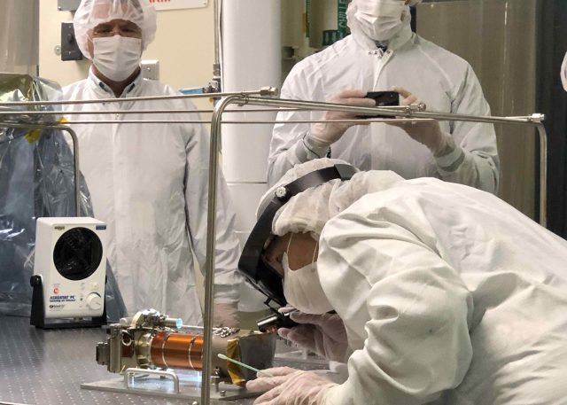 A JPL technician carefully inspects one of the flight Mastcam-Z cameras after it was officially delivered from the team to the rover in May 2019.